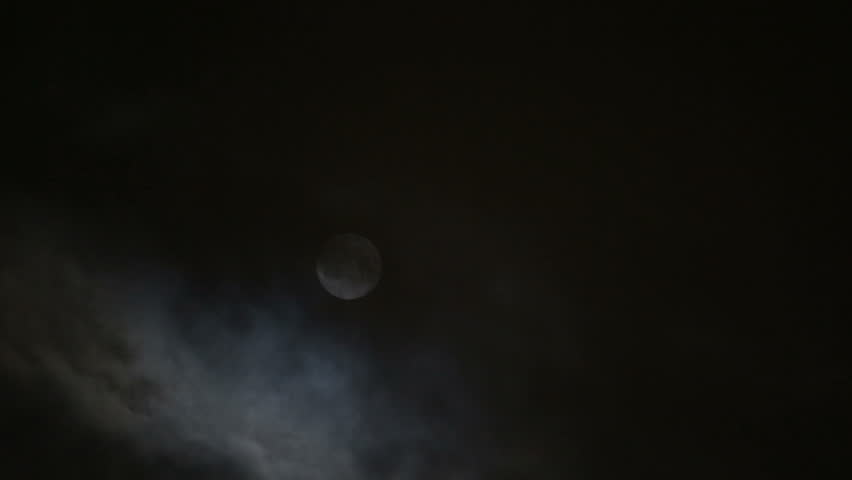 timelapse with moon moving between clouds