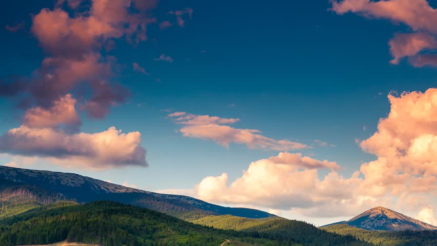 Time lapse clip. Majestic mountain landscape with colorful cloud. Dramatic sky.