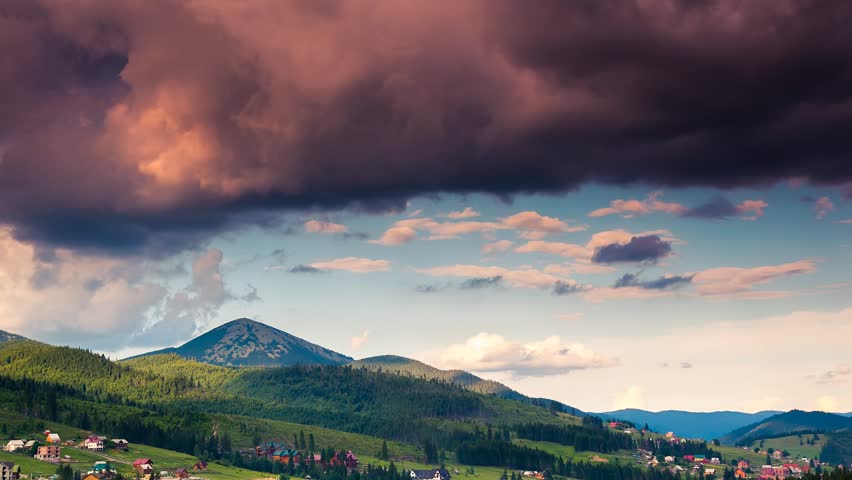 Time lapse clip. Majestic mountain landscape with colorful cloud. Dramatic sky.