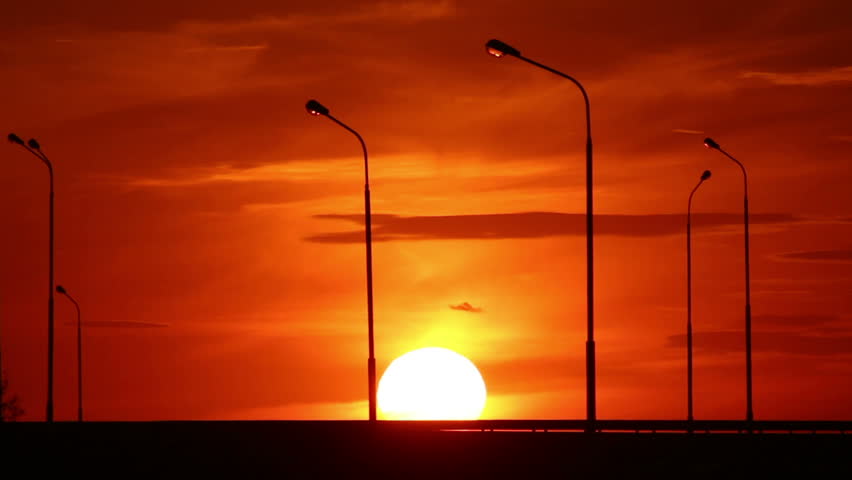 Cars silhouettes on road against sunset - timelapse
