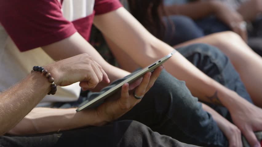 Friends using tablet and hang out