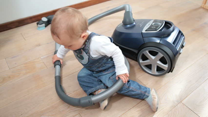 baby and vacuum cleaner