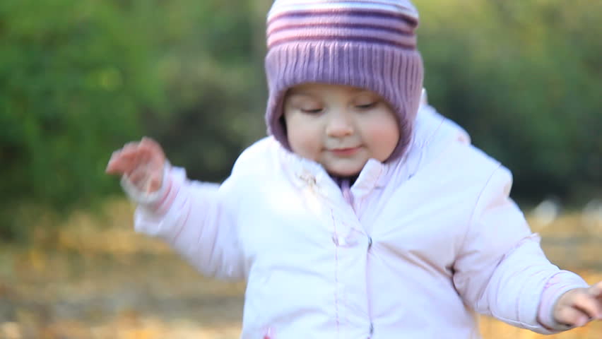 Cute baby walks in park