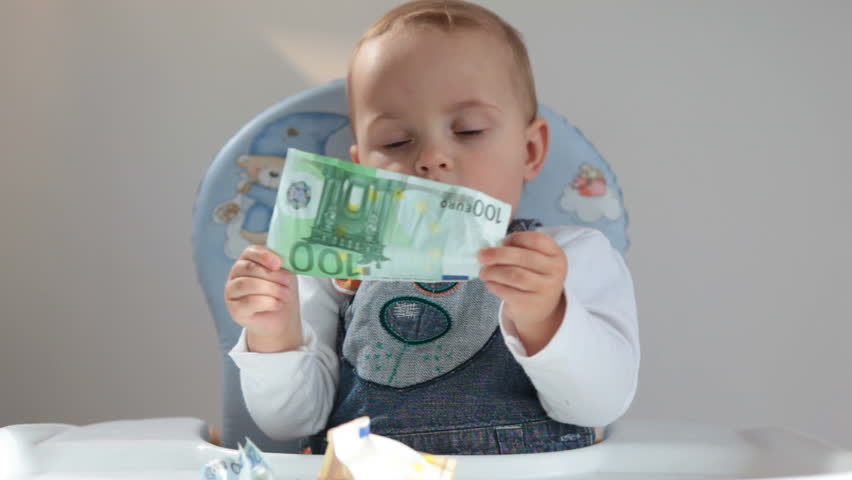 Baby plays with Euro notes