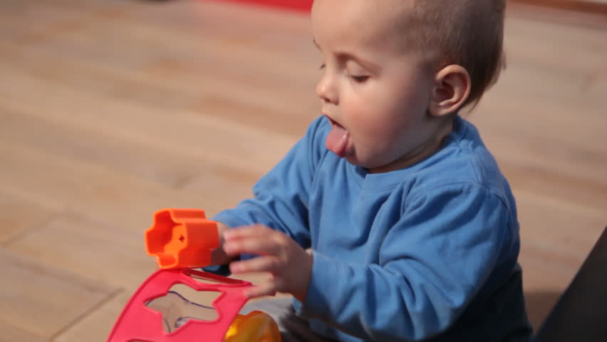 Cute baby girl plays with puzzles