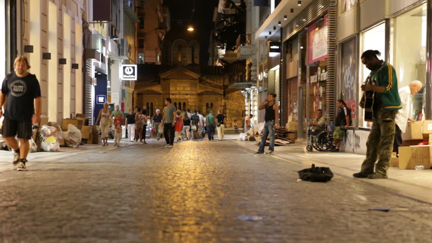 Athens, Greece - August 15th, 2012: Street at night with buskers