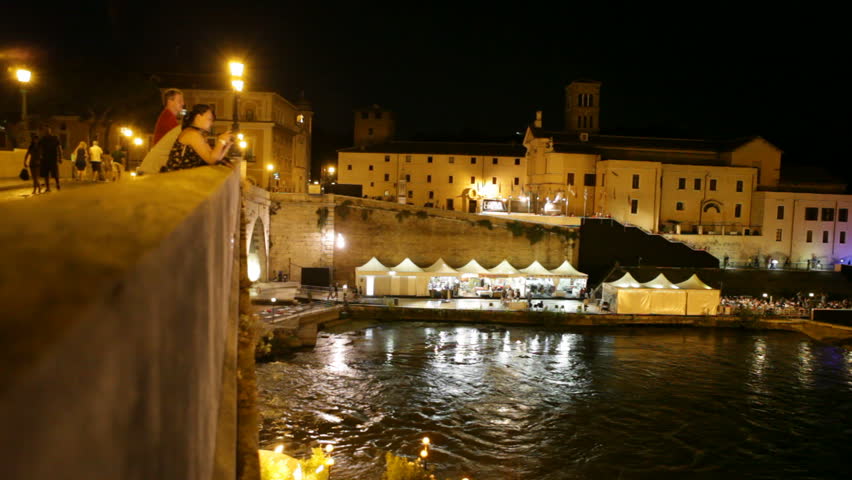 Rome, Italy - February 15th, 2012 -  People on bridge to Isola Tiberina
