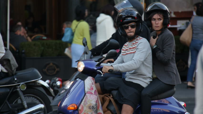 Paris, France - May 6th, 2012: Couple on scooter in Paris
