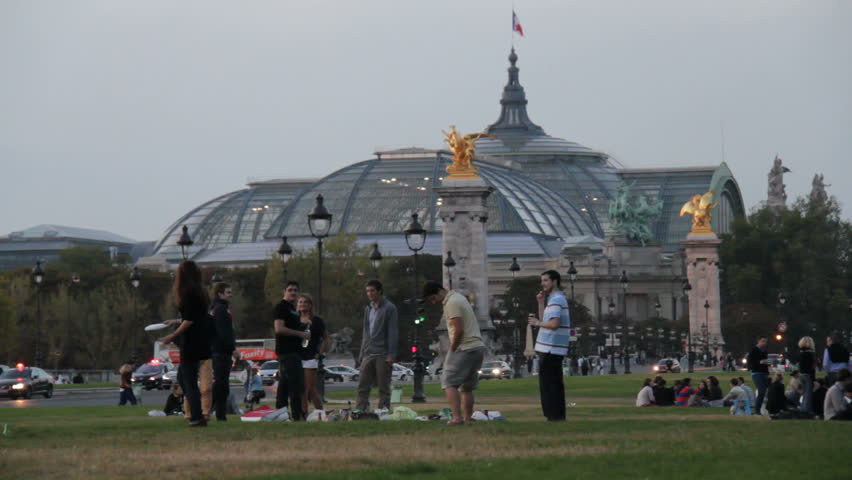 Paris, France - May 6th, 2012: Friends relax in park in Paris