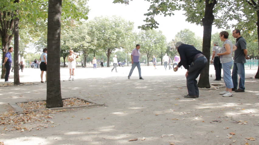 Paris, France - May 6th, 2012: Elderly man plays boules in Paris