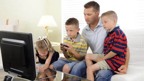 A father with his children playing video games.