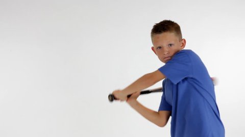 A young boy with a baseball bat practicing his swing.