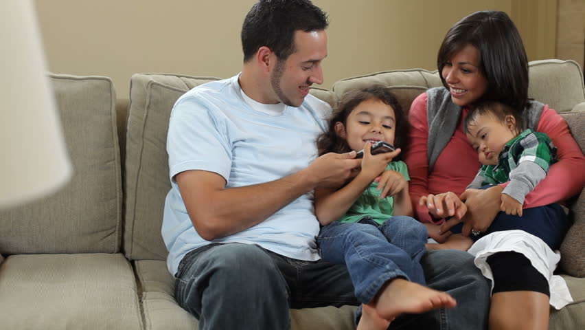 Family sitting down to look at phone | Shutterstock HD Video #4801076