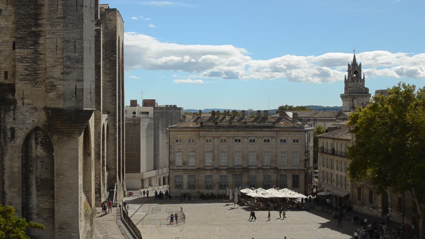 AVIGNON, FRANCE - September 18, 2013: Tourists sightseeing at the Papal Palace in Avignon. The well-preserved city center is listed as a UNESCO World Heritage site.
