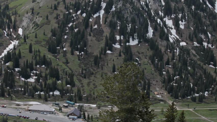 Town of Alta, Little Cottonwood canyon, Salt Lake city, Utah. Mountain and valley, forest and melting snow. Summer and winter resort. Wasatch Mountains. Pan through valley.