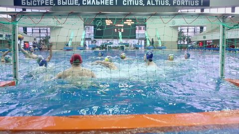 MOSCOW - APR 20: Man tries to score goal during match of teams Astana and Dynamo on water polo in basin of Olympic Sports complex on 20 April 2012 in Moscow, Russia. Water polo invented at UK in XIX