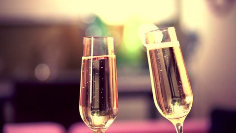 Champagne. Two Glases with Sparkling Champagne Toasting over Holiday Bokeh Blinking Background. Slow motion. Stock Video