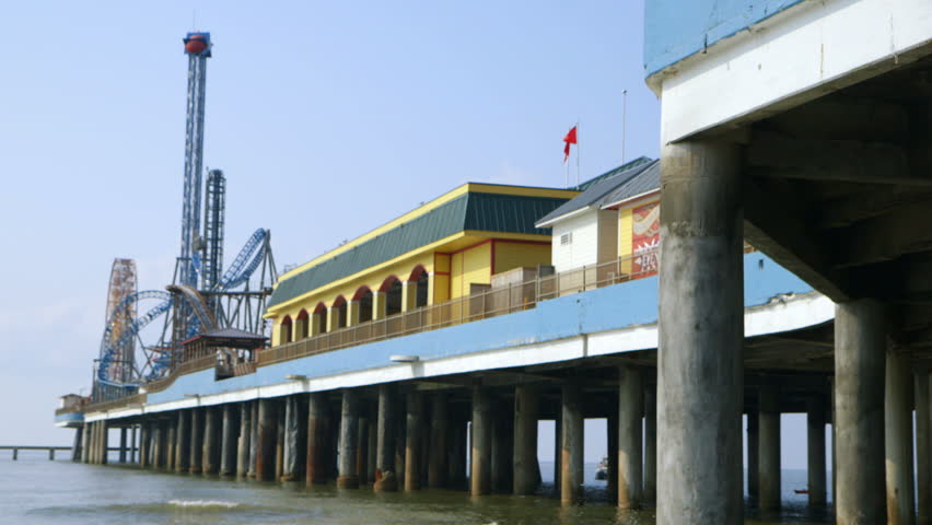 View from beach level to long wharf on which carnival site in Galveston TX is built.