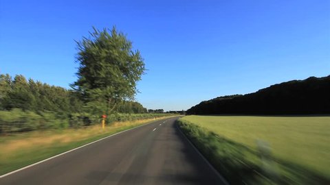 Driving a Car - Driving through a rural landscape in Germany.
Shot with a roof-mounted camera, the car is driving with moderate speed.