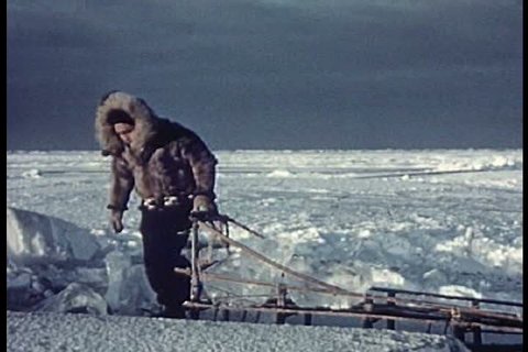 1950s - Eskimos take ice by dogsled to the village while others go ice fishing.