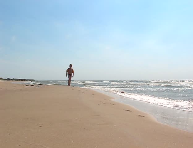 child runs along the shore