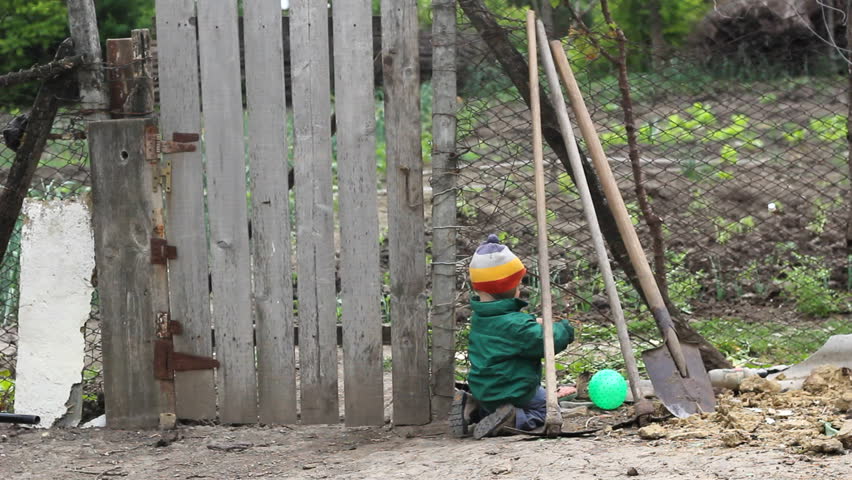 Little baby play in rural courtyard