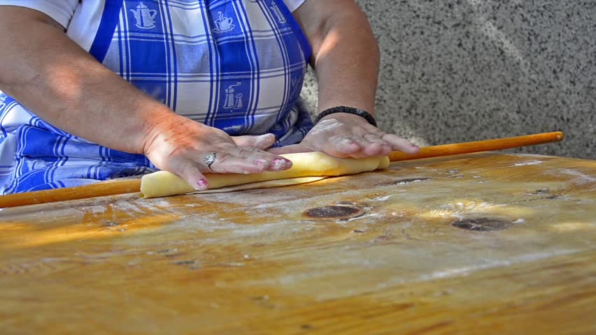 Cakes preparation - Stock Video. Old traditional way of dough flattening. Adding
