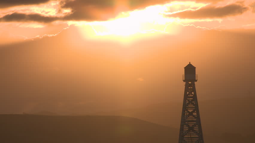 sunset over an old navigation beacon/lighthouse