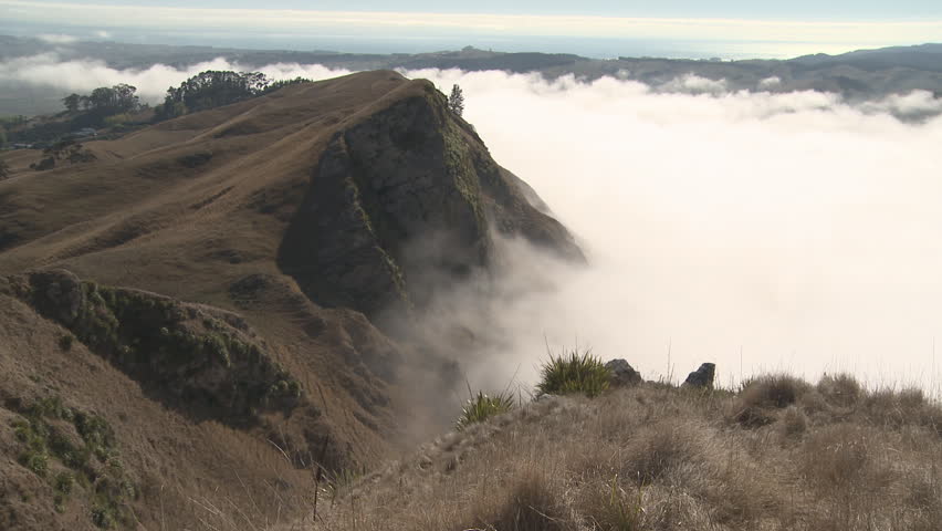Early morning fog clears from hilltops in time lapse