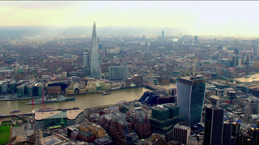 Panoramic aerial shot along the River Thames in Central London, UK. Features The Shard building, bridges and the Millennium Wheel / London Eye in the background.