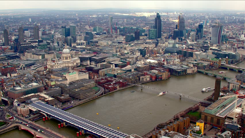 Panoramic aerial shot of the City of London financial district skyline. Features St Paul's Cathedral, Tower 42, the Gherkin / 30 St Mary Axe building and other famous landmarks. Royalty-Free Stock Footage #4835522