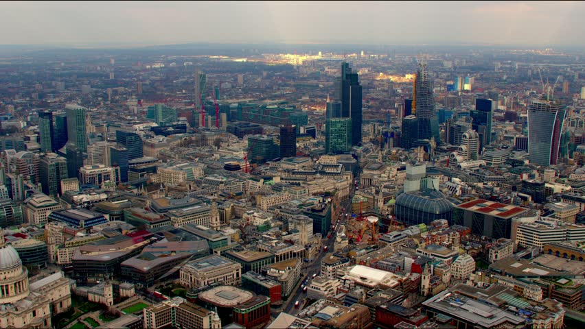 Dramatic aerial shot of the City of London financial district skyline. Features the Gherkin / 30 St Mary Axe building and other famous landmarks. Royalty-Free Stock Footage #4835525
