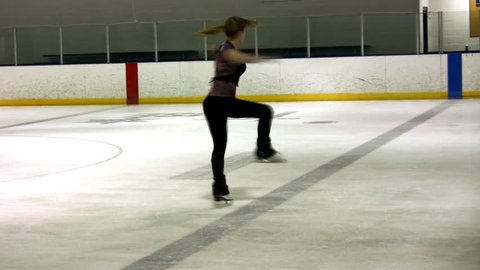 A lovely figure skater performs a very fast scratch spin
