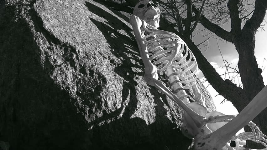 Skeleton HIllside Black and White 2. Skeleton resting on a picturesque country