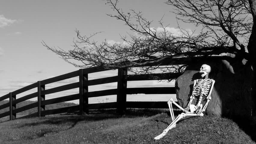 Skeleton HIllside Blank and White 1. Skeleton resting on a picturesque country