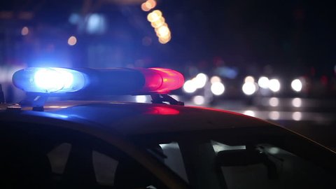Police lights flashing at night downtown