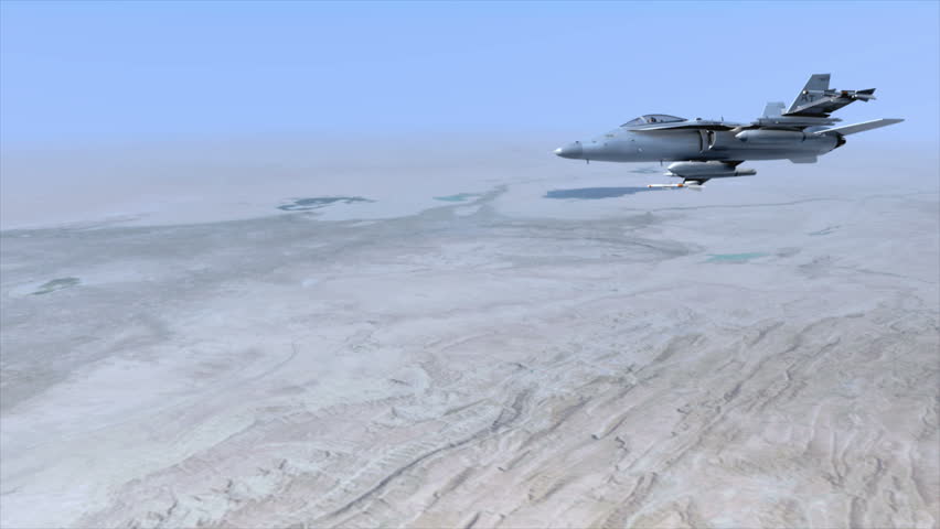 An F18 Hornet flying over the Middle East. The pilot turns his head towards the