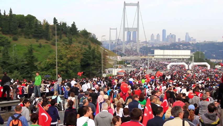 ISTANBUL - OCT 17: Crowd of people walk from Asia to Europe through Bosporus