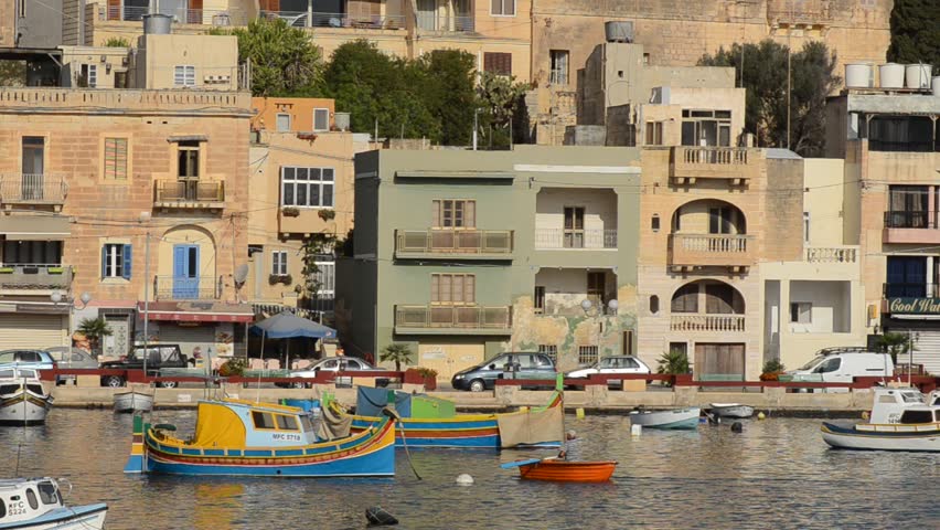 Traditional brightly painted boats in the harbor in Marsaskala, Malta