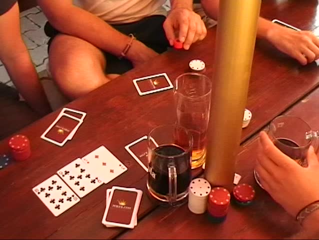 Poker Players With Cards On Table.
