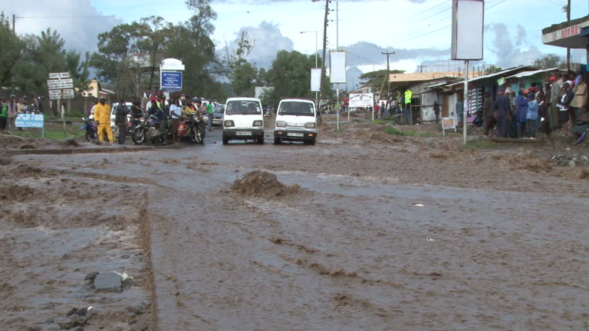 Rain floods a road in a town
