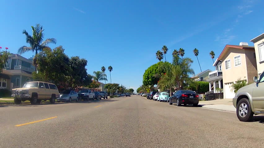 The point of view of someone riding a bicycle on the street of a residential