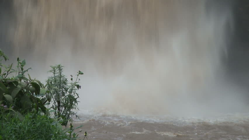 waterfalls from a swollen river
