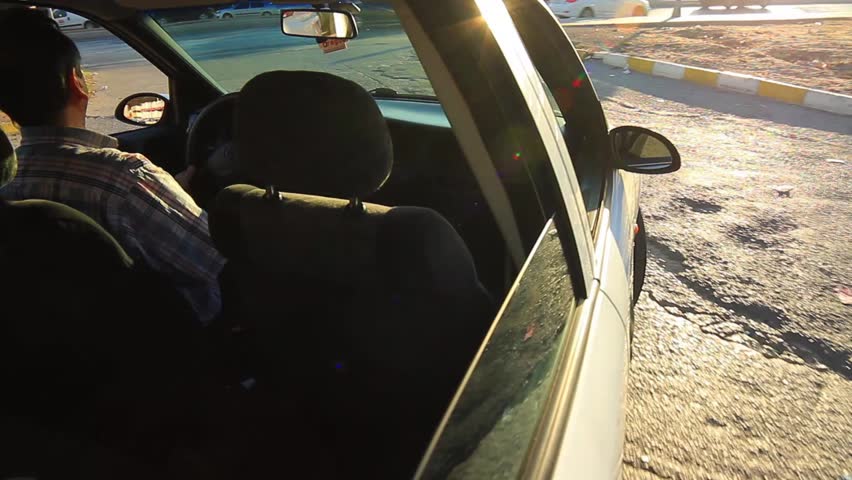Man driving around and enjoying the sun. Car mounted camera.
