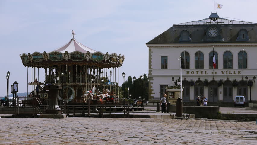 Rotating carousel in harbor of Honfleur, France