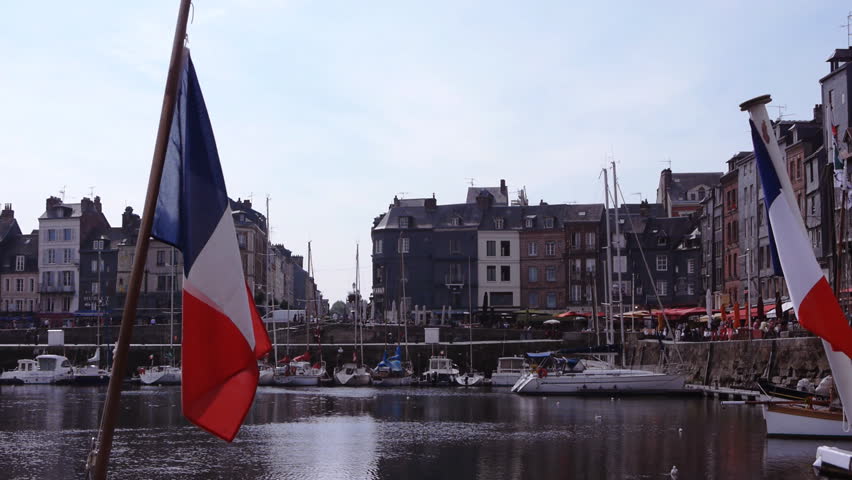 Waving flags in harbour of Honfleur, France