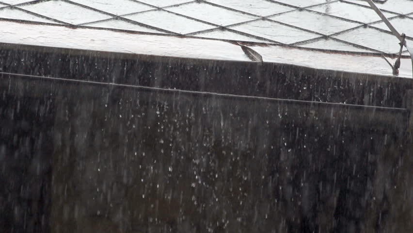 Slow Motion Of Heavy Rain. Raindrops Pouring Off The Roof Of A Building.