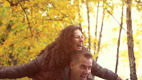 Autumn. Happy Couple Having Fun Outdoors. Laughing Joyful Family. Freedom Concept. Autumnal Park. Fall