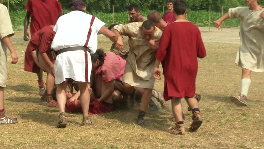 AQUILEIA - JUNE 22: Roman legionary play Harpastum (a form of ball game played