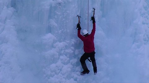 ONTARIO, CANADA-CIRCA 2012-A man climbing a frozen waterfall.